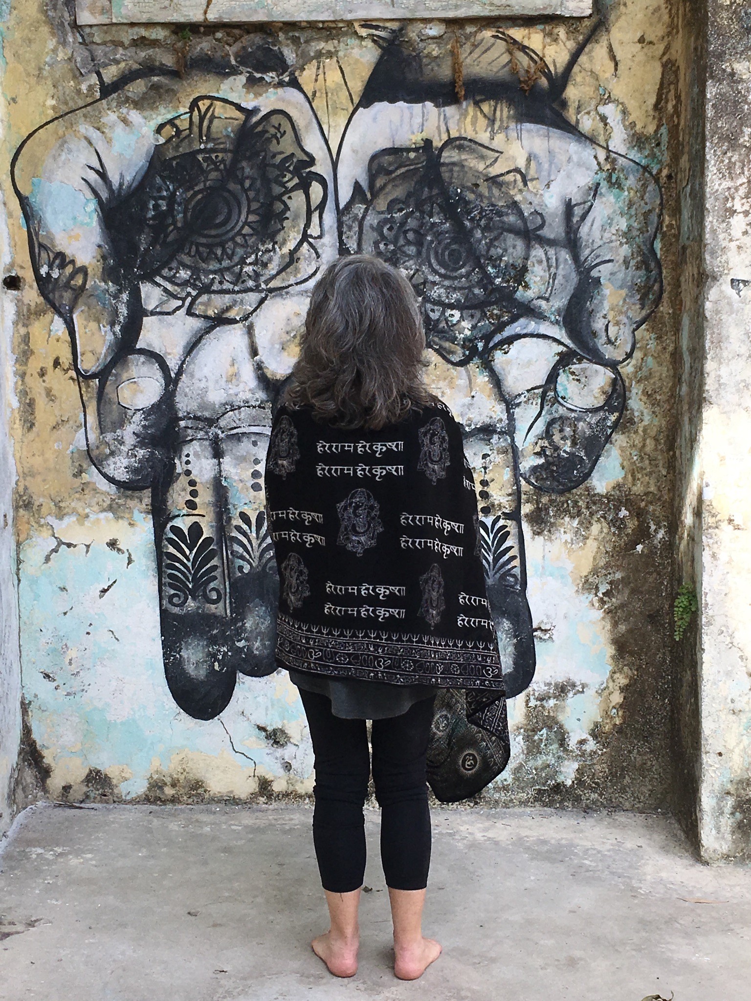 Colette standing in front of an ornate elephant mural
