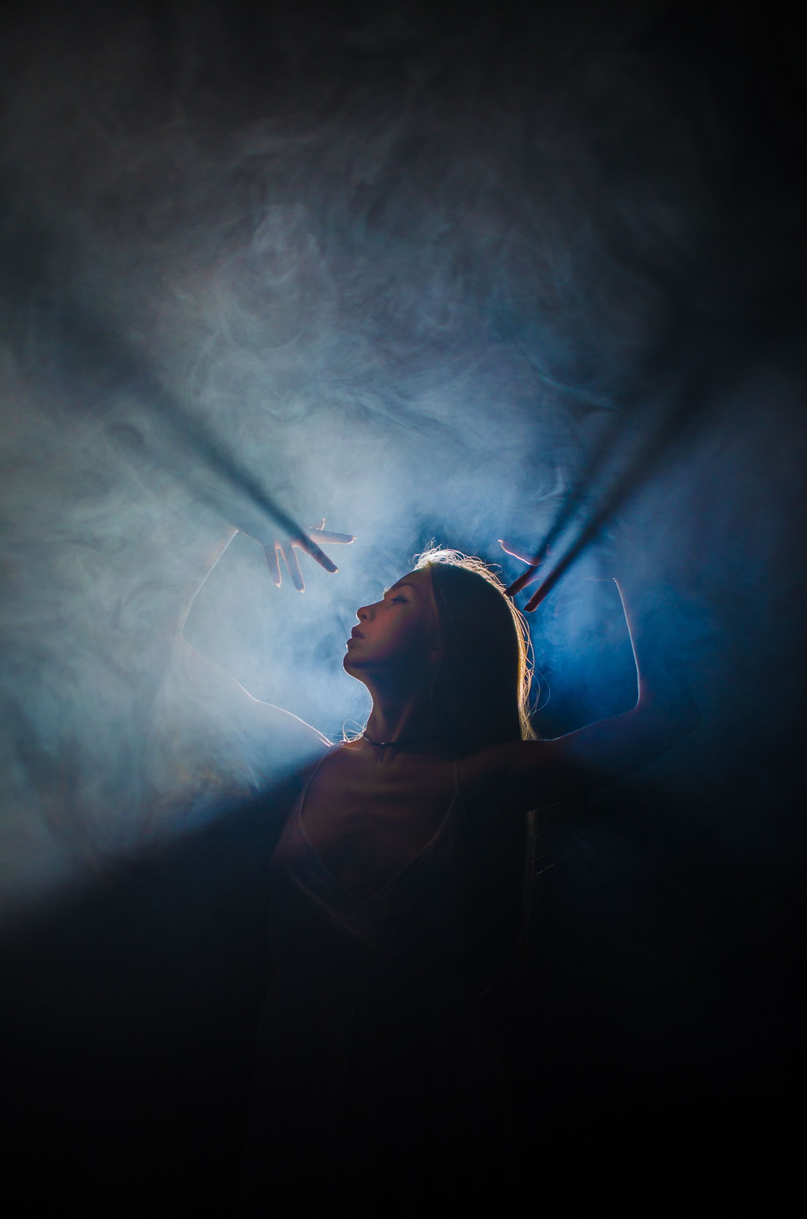 A reclining figure illuminated by soft blue light